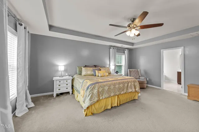 a spacious bedroom with a bed and a couch