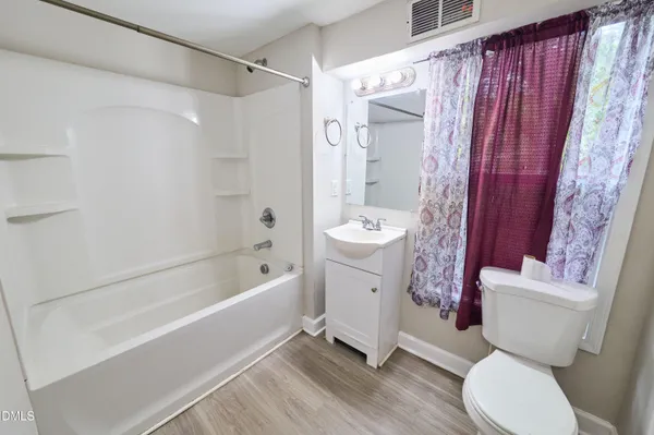 a bathroom with a toilet a sink and bathtub