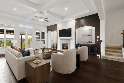a living room with fireplace furniture and a flat screen tv