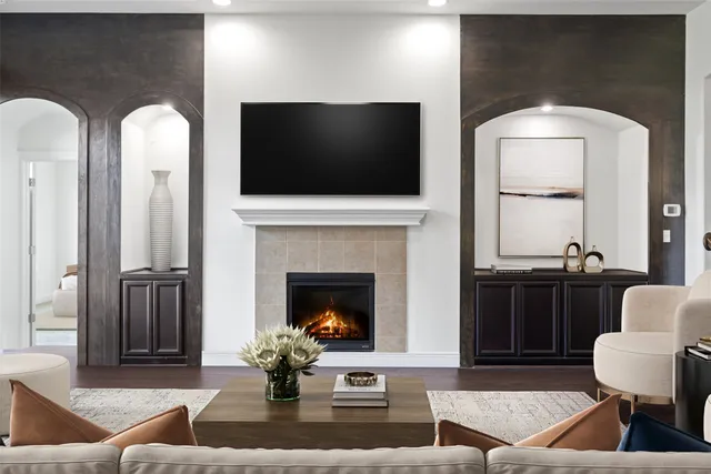 a living room with furniture a flat screen tv and a fireplace