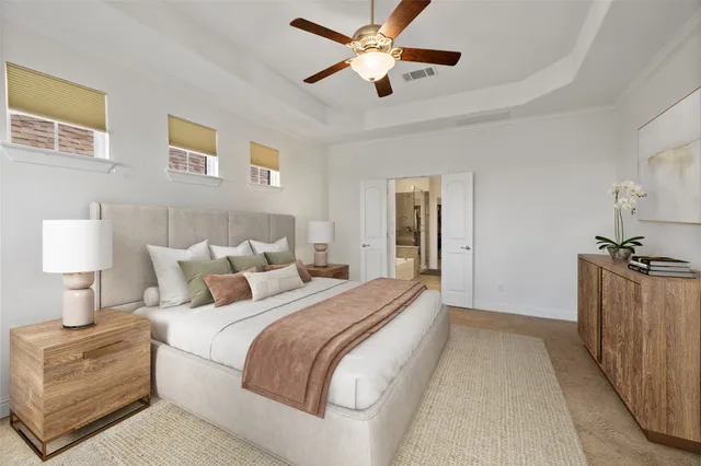 a spacious bedroom with a bed and a lamp