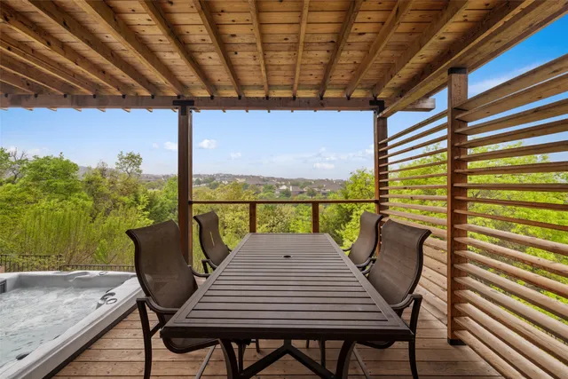 a view of a balcony with table and chairs and wooden floor