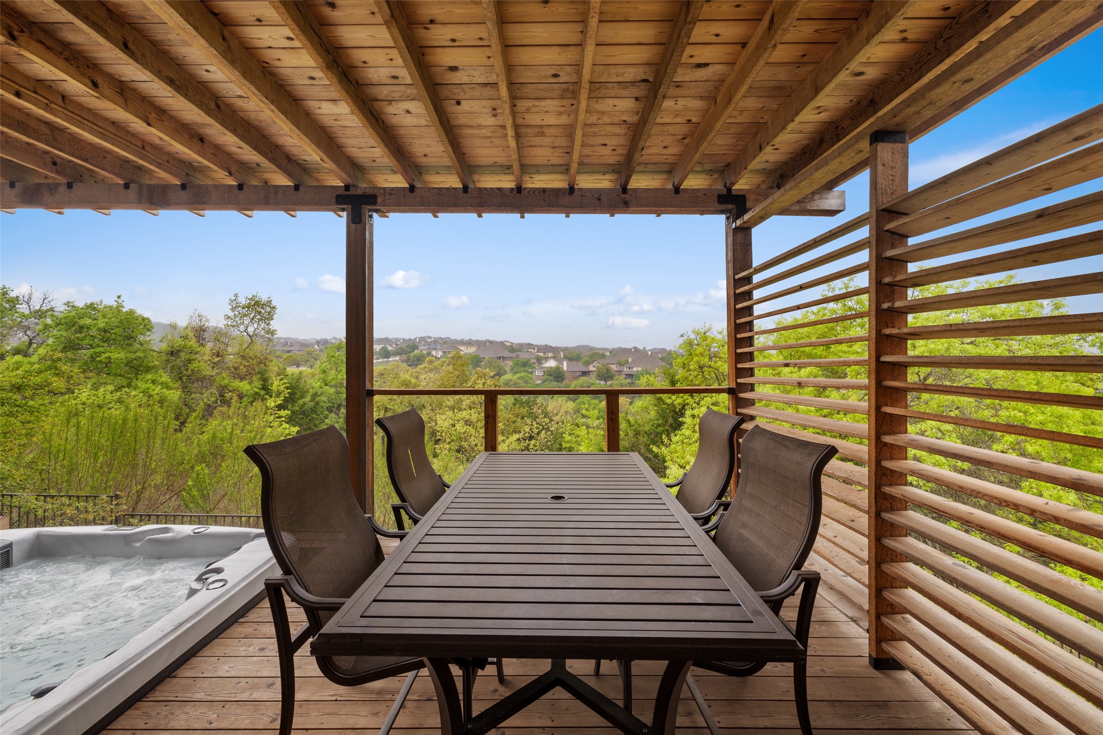 5612 Cherokee Draw Road Austin, TX 78738 - Photo 29 of 31 a view of a balcony with table and chairs and wooden floor