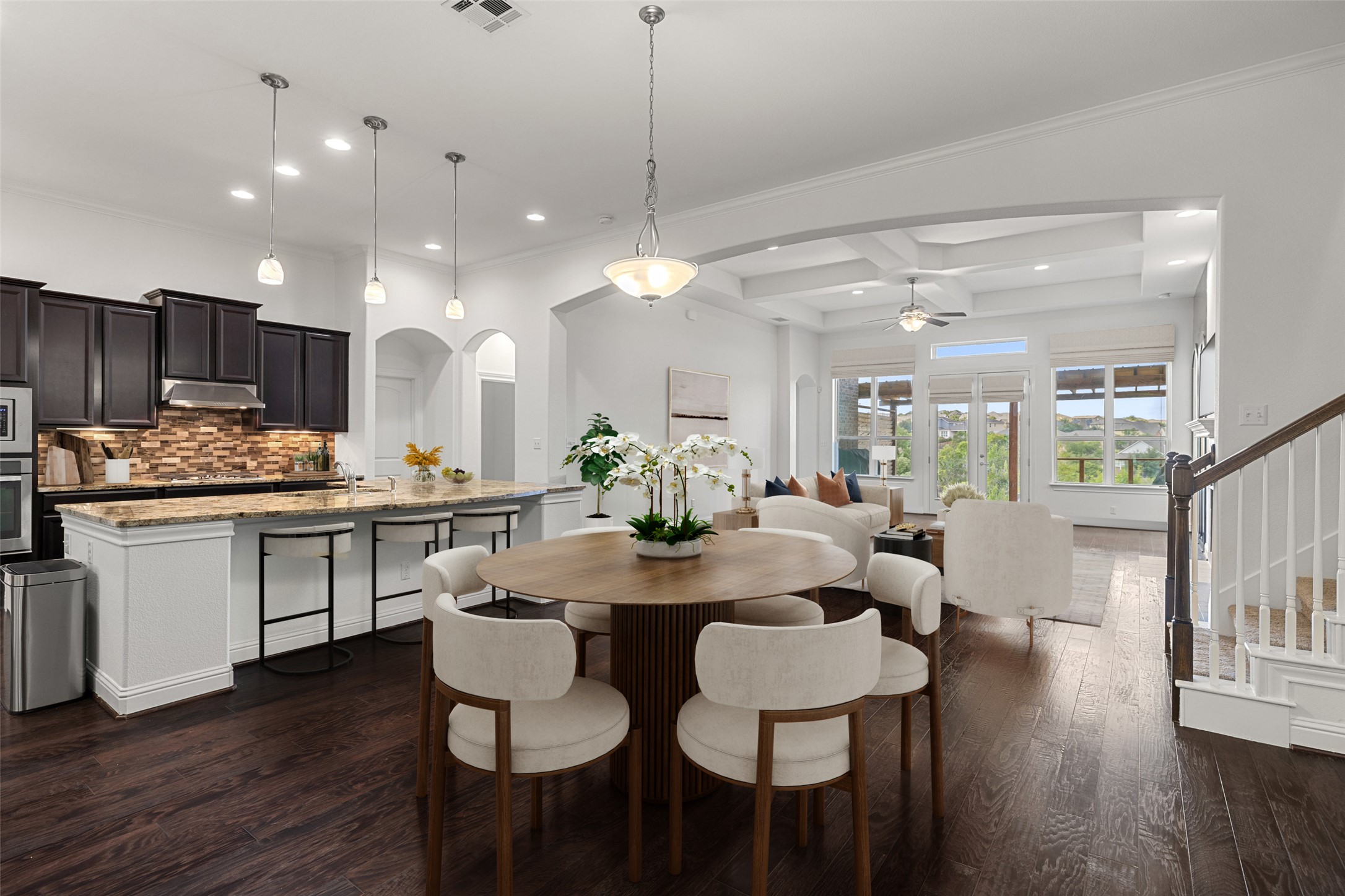 5612 Cherokee Draw Road Austin, TX 78738 - Photo 8 of 31 a kitchen with a dining table chairs wooden floor appliances and cabinets