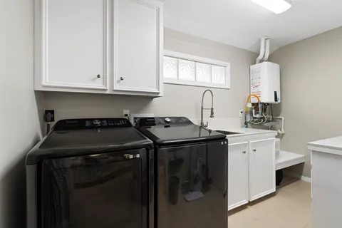 a kitchen with a stove and white cabinets