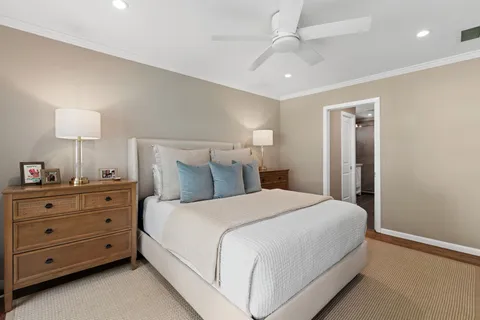 a bedroom with a bed and a night stand