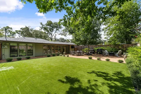 a view of a house with swimming pool and sitting area