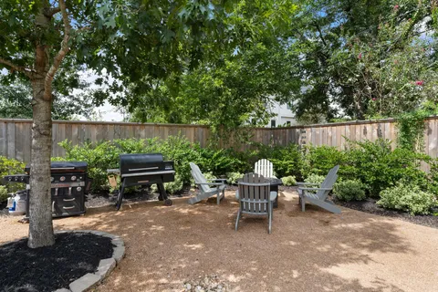 a view of a chairs and tables in the back yard of the house