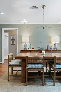 a room with a table a chairs and a wooden floor