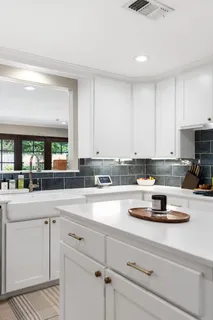 a kitchen with a stove a sink and cabinets