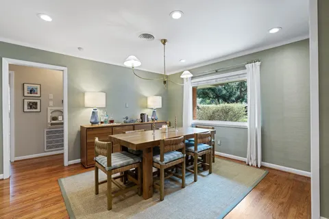 a view of a dining room with furniture window and wooden floor