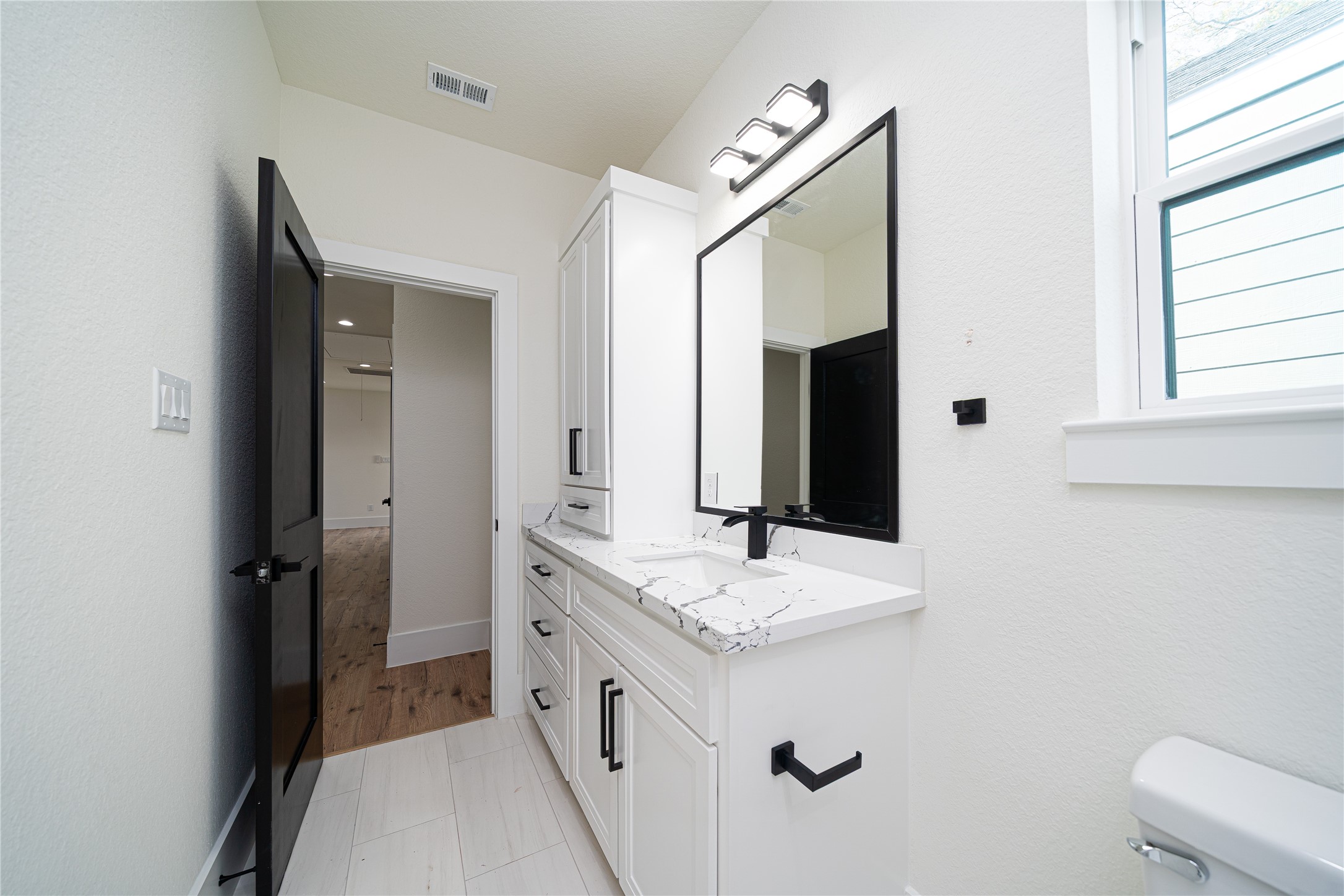 2429 Parker Road Houston, TX 77093 - Photo 11 of 17 a bathroom with a double vanity sink and mirror