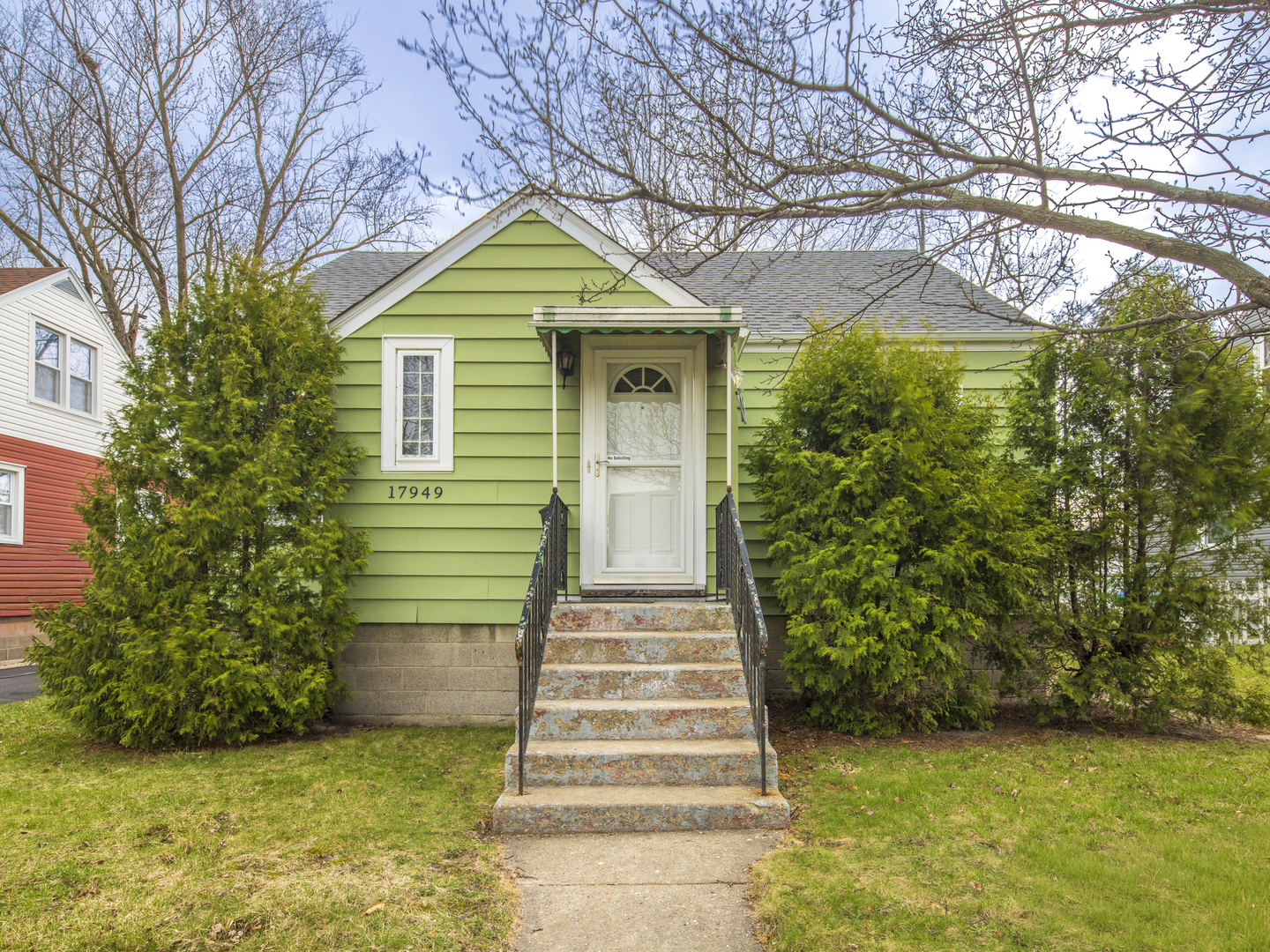 17949 Escanaba Avenue Lansing, IL 60438 - Photo 1 of 45 a front view of a house with a yard and trees