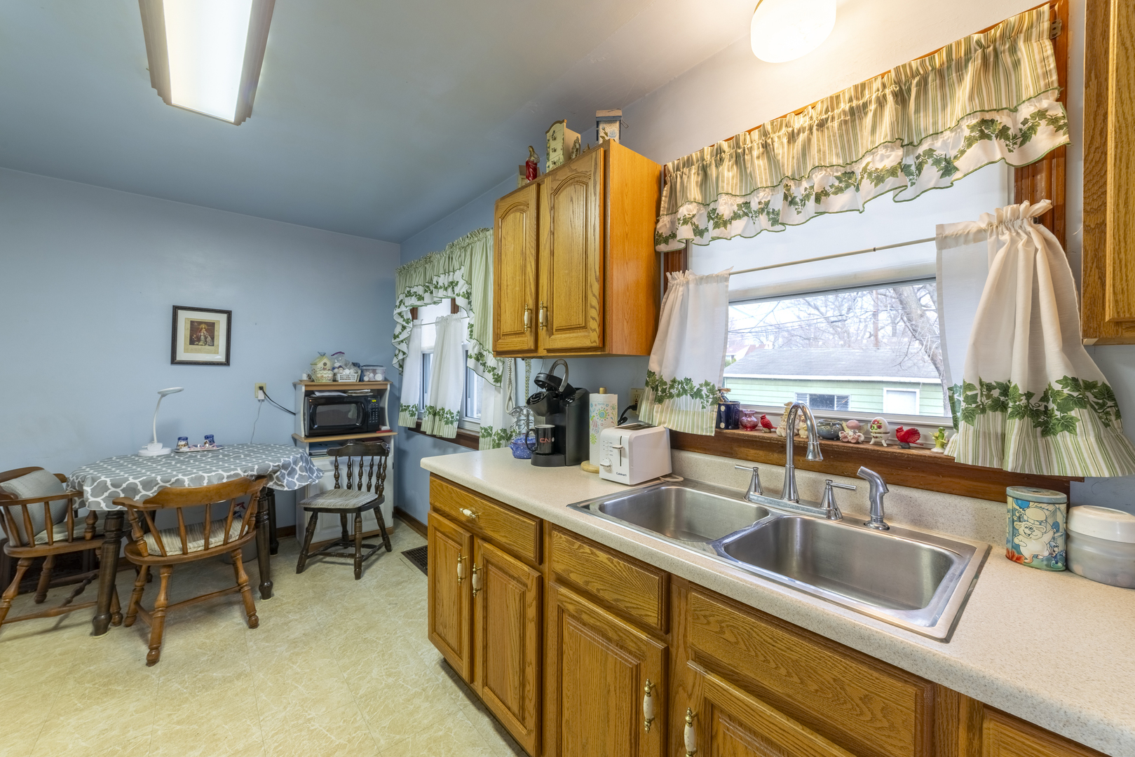 17949 Escanaba Avenue Lansing, IL 60438 - Photo 13 of 45 a kitchen filled counter top space a sink cabinets and a window