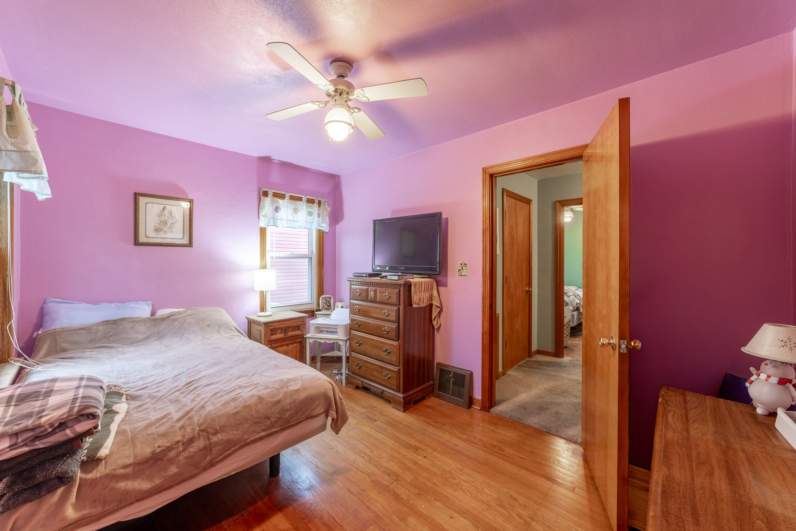 17949 Escanaba Avenue Lansing, IL 60438 - Photo 15 of 45 a bedroom with a bed and a chandelier