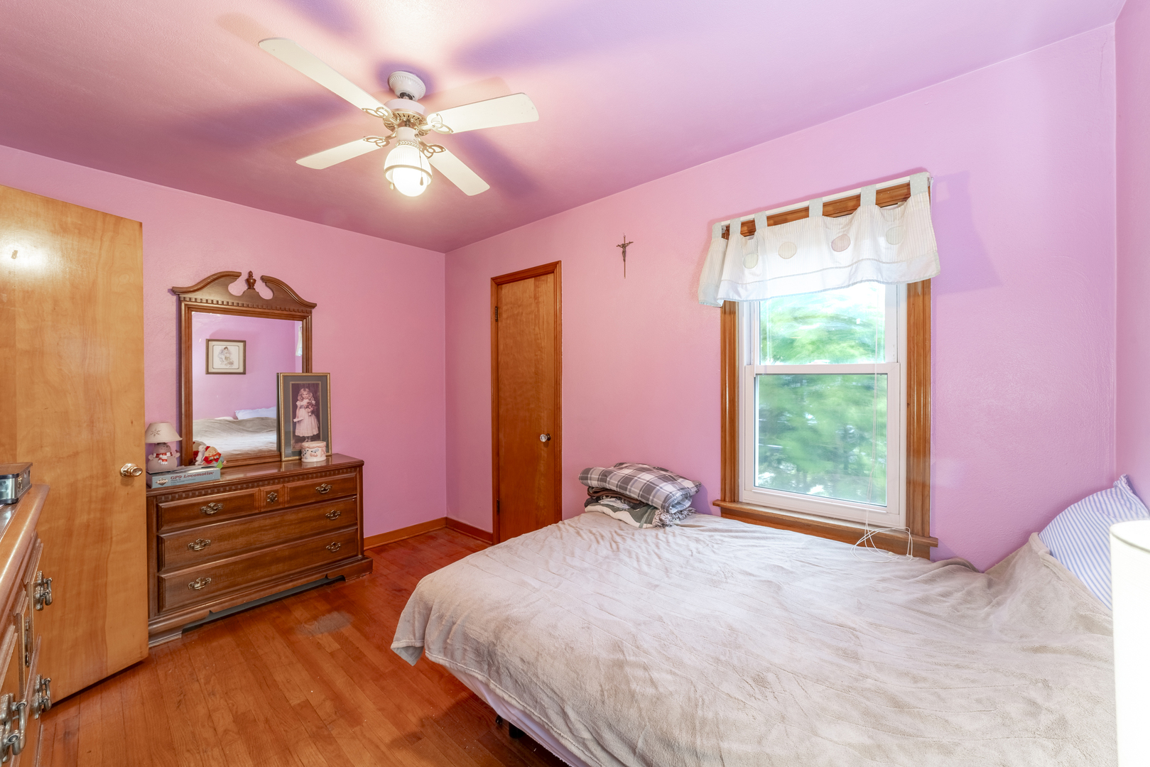 17949 Escanaba Avenue Lansing, IL 60438 - Photo 16 of 45 a bedroom with a bed and a chandelier