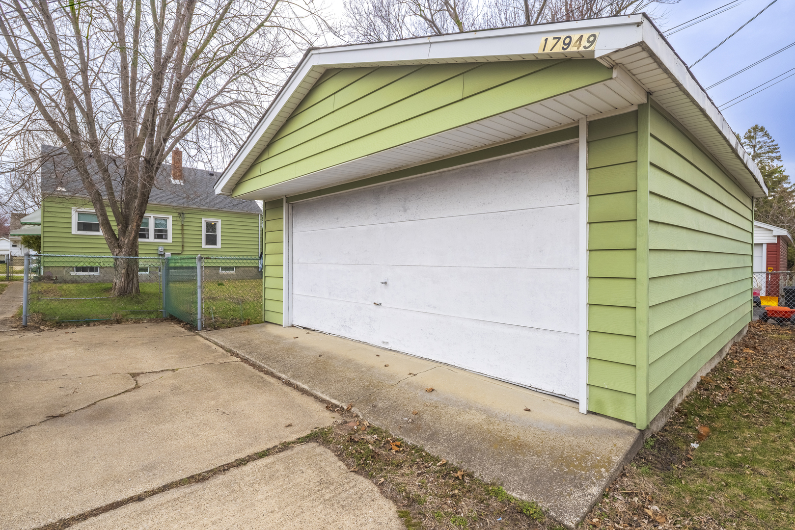 17949 Escanaba Avenue Lansing, IL 60438 - Photo 44 of 45 a small white building with a white roof and wooden fence