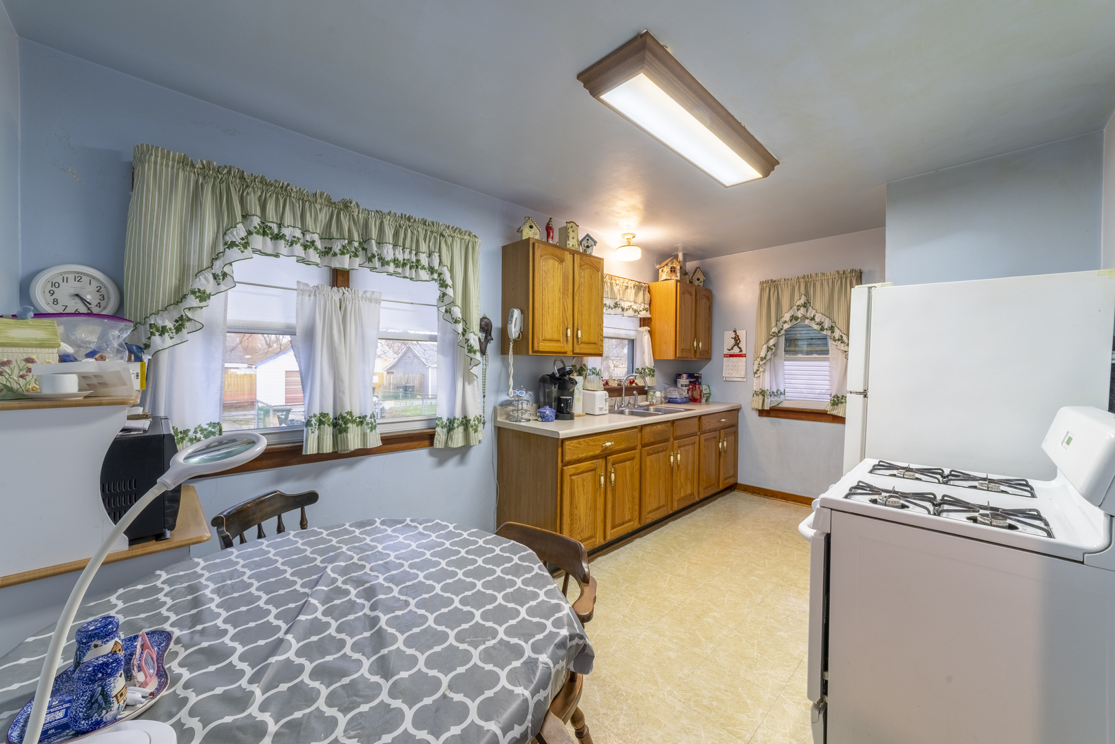 17949 Escanaba Avenue Lansing, IL 60438 - Photo 7 of 45 a large kitchen with a window a counter top space a sink stainless steel appliances and cabinets