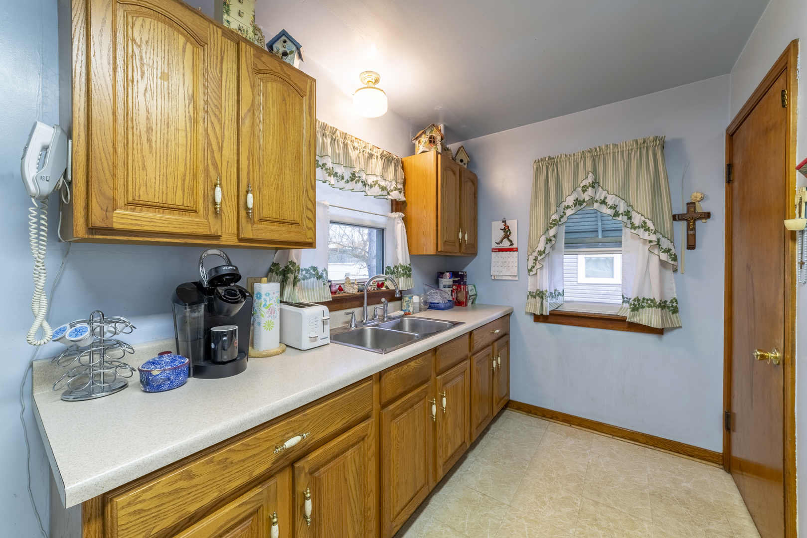 17949 Escanaba Avenue Lansing, IL 60438 - Photo 8 of 45 a kitchen with sink cabinets and window