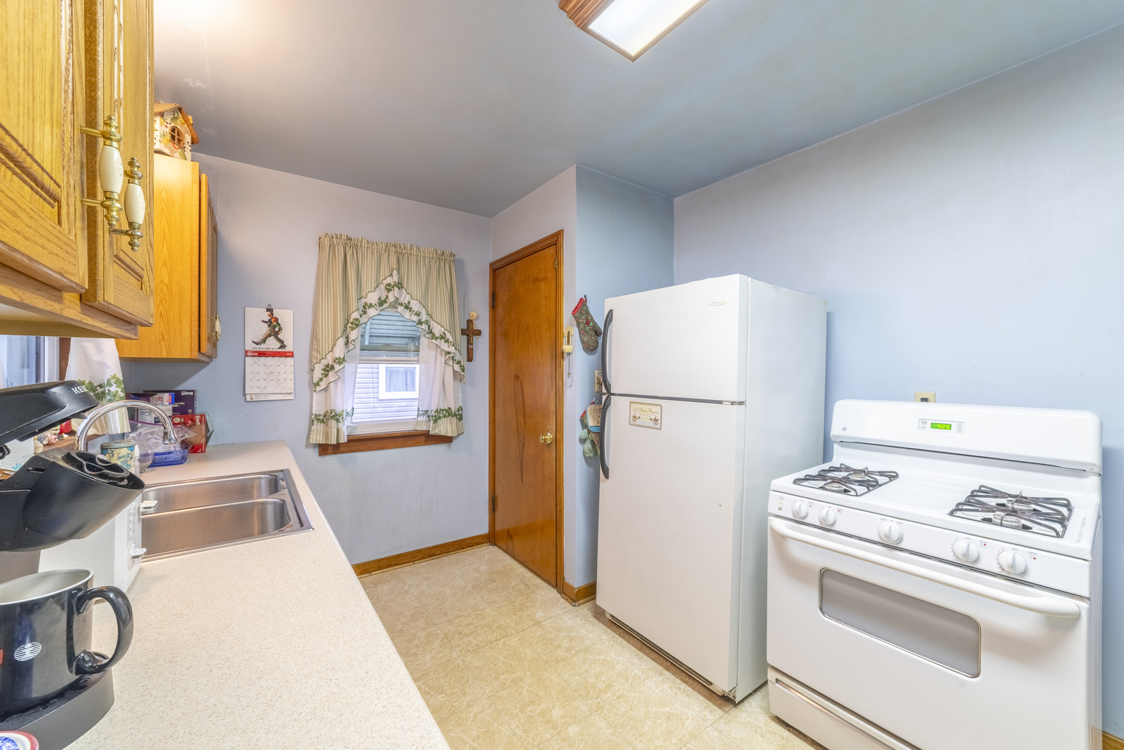 17949 Escanaba Avenue Lansing, IL 60438 - Photo 10 of 45 a kitchen with a refrigerator and a stove