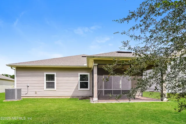 a view of house with backyard