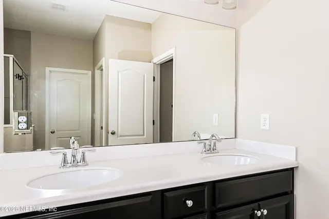 a bathroom with a sink and a mirror