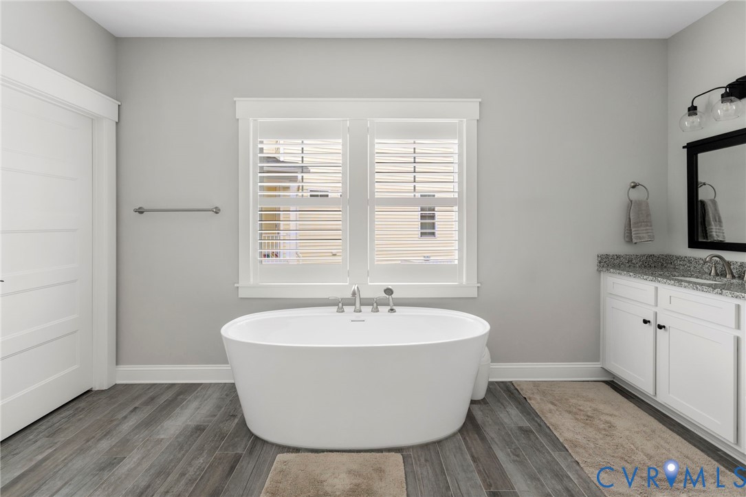 15060 Dordon Lane Midlothian, VA 23112 - Photo 22 of 35 a white bath tub sitting in a spacious bathroom next to a window
