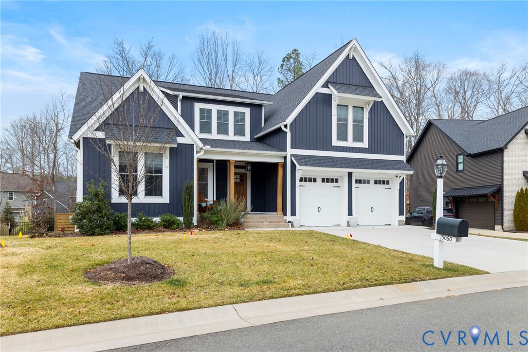 15060 Dordon Lane Midlothian, VA 23112 - Photo 3 of 35 a front view of a house with a yard and garage