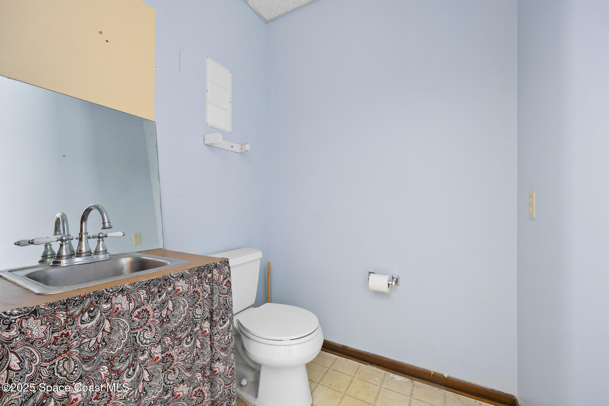 700 North Wickham Road, Unit 109 Melbourne, FL 32935 - Photo 5 of 13 a bathroom with a sink and a toilet