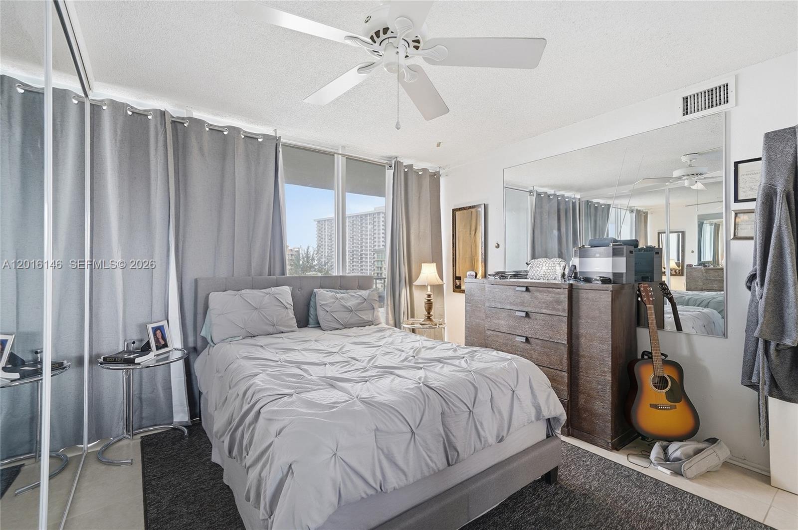 521 North Riverside Drive, Unit 606 Pompano Beach, FL 33062 - Photo 22 of 50 a bedroom with a bed and wooden floor