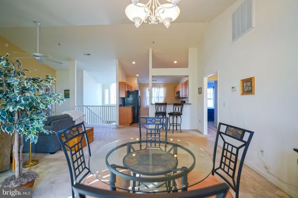 a dining room with furniture a chandelier and wooden floor