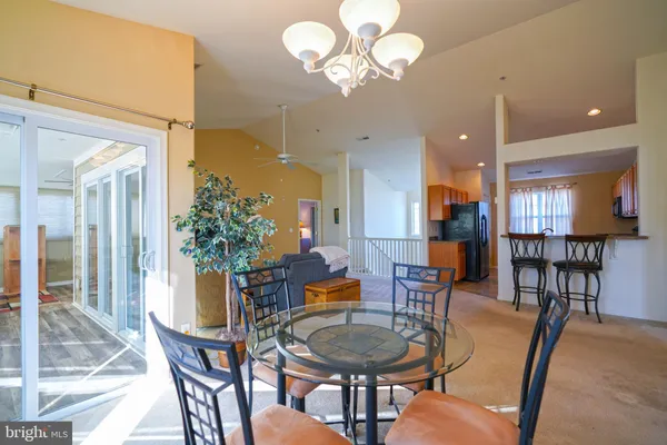 a dining room with furniture a chandelier and wooden floor