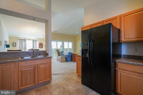 a kitchen with a refrigerator and a sink