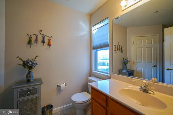 a bathroom with a sink toilet and mirror