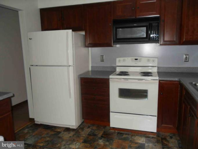 2921 Warehime Road Manchester, MD 21102 - Photo 22 of 30 a white refrigerator freezer and a stove sitting inside of a kitchen