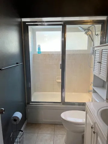 a view of empty room with window and wooden floor