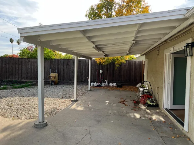 a view of a house with backyard and porch