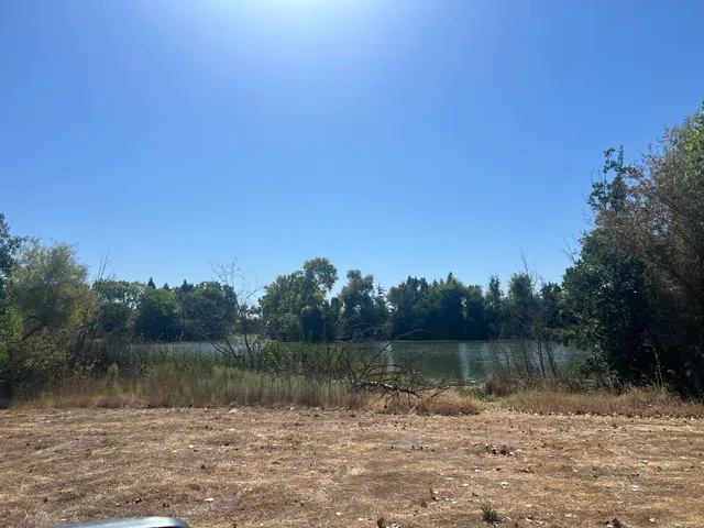 a view of a lake with trees in the background