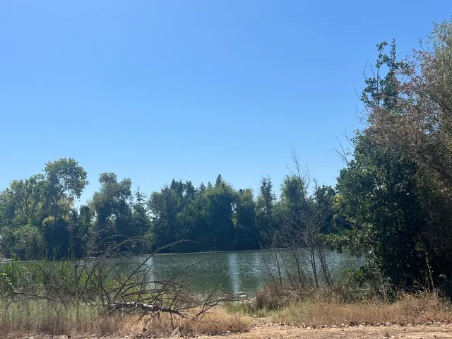 a view of a lake in between two and trees