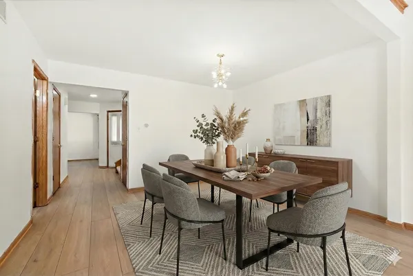a view of a dining room with furniture and wooden floor