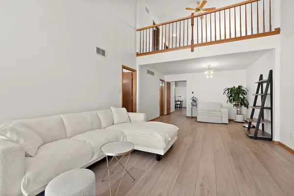 a living room with furniture and wooden floor