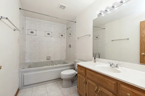 a bathroom with a double vanity sink toilet mirror and bathtub