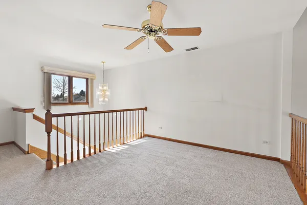 a view of a livingroom with a ceiling fan and window