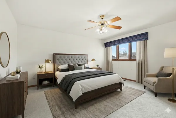 a bedroom with a bed mirror and window