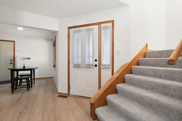 a view of entryway and hall with wooden floor