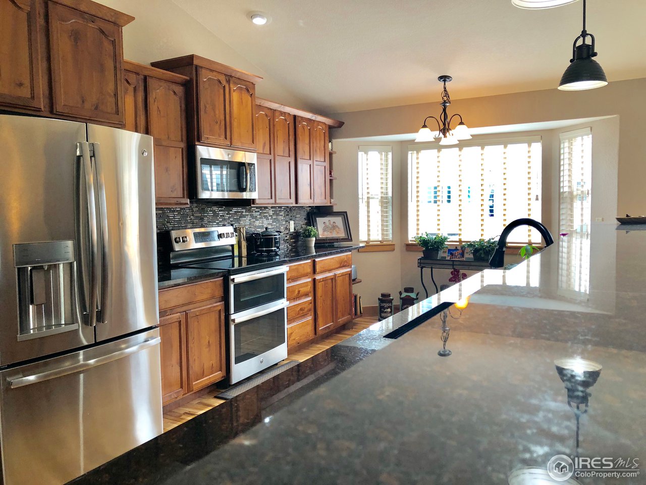 333 Braveheart Road Johnstown, CO 80534 - Photo 5 of 32 Bright Upgraded Kitchen with Granite Counters