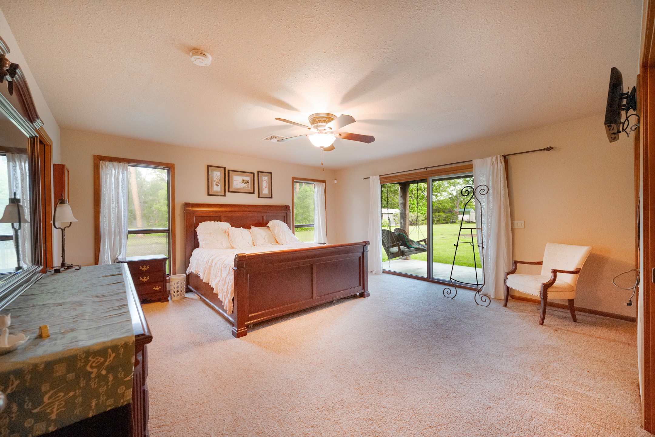 2210 Rita Street El Campo, TX 77437 - Photo 9 of 22 a spacious bedroom with a bed and a chandelier