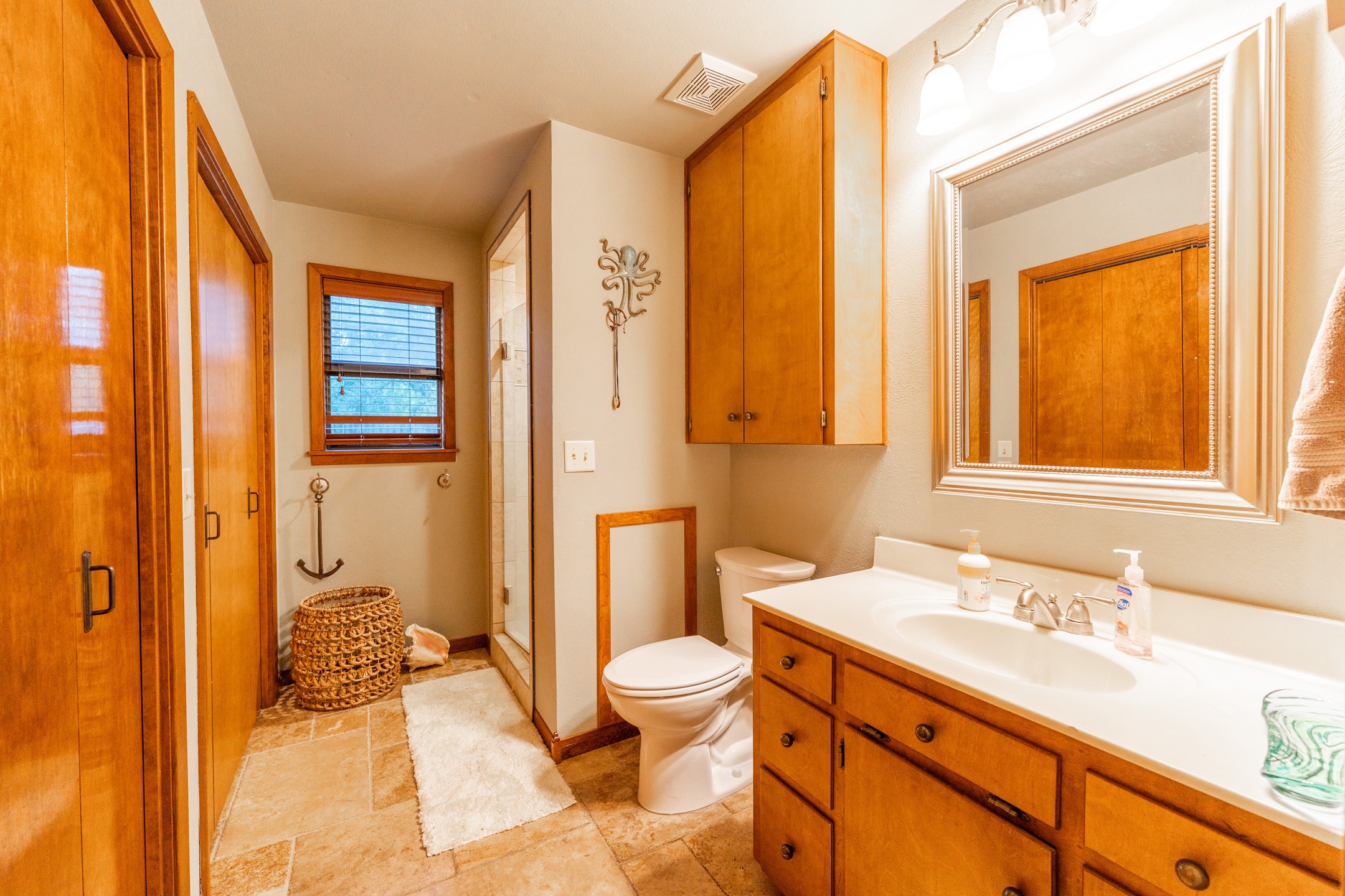 2210 Rita Street El Campo, TX 77437 - Photo 10 of 22 a bathroom with a granite countertop sink toilet and shower