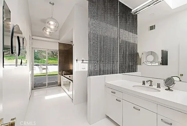 a large white kitchen with a large window