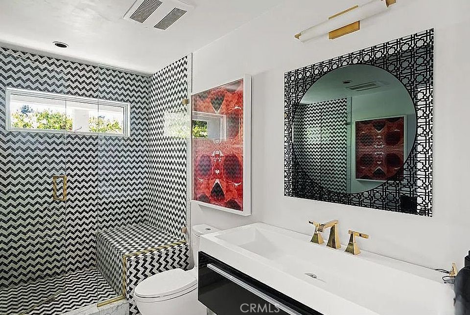 1030 San Rafael Lane Pasadena, CA 91105 - Photo 38 of 56 a bathroom with a toilet sink vanity and mirror